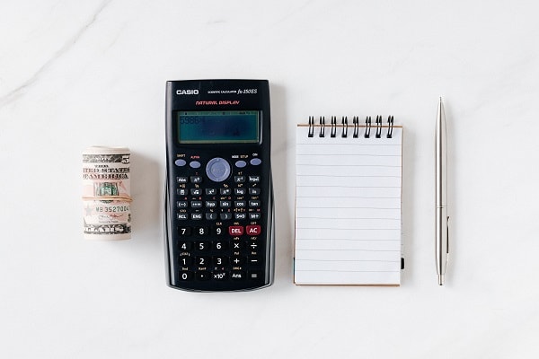 rolled up cash calculator notepad pen minimalist budget