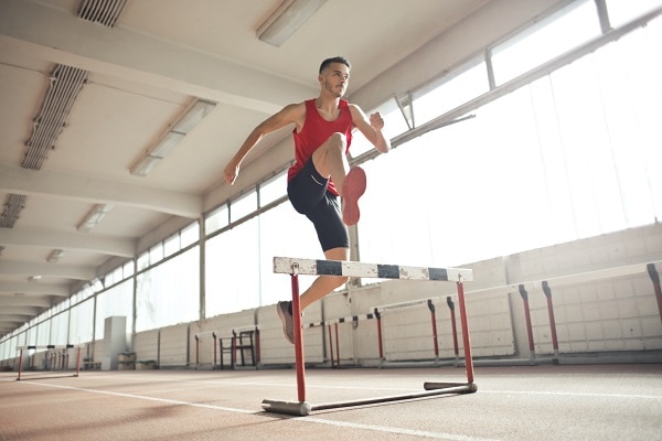 Man jumping hurdle my top 40 perseverance quotes when facing adversity