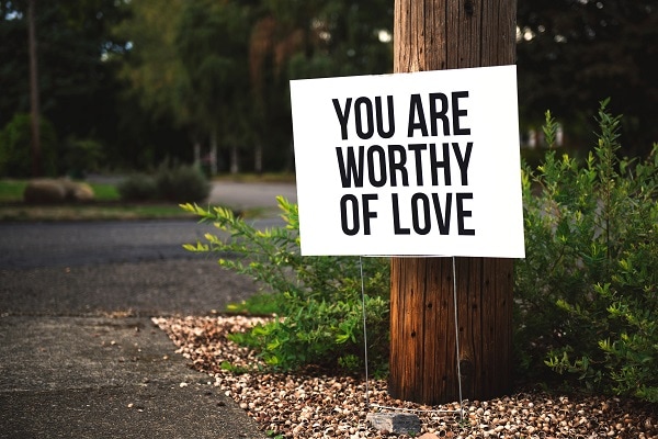sign saying you are worthy of love. encouragement to practice self-love