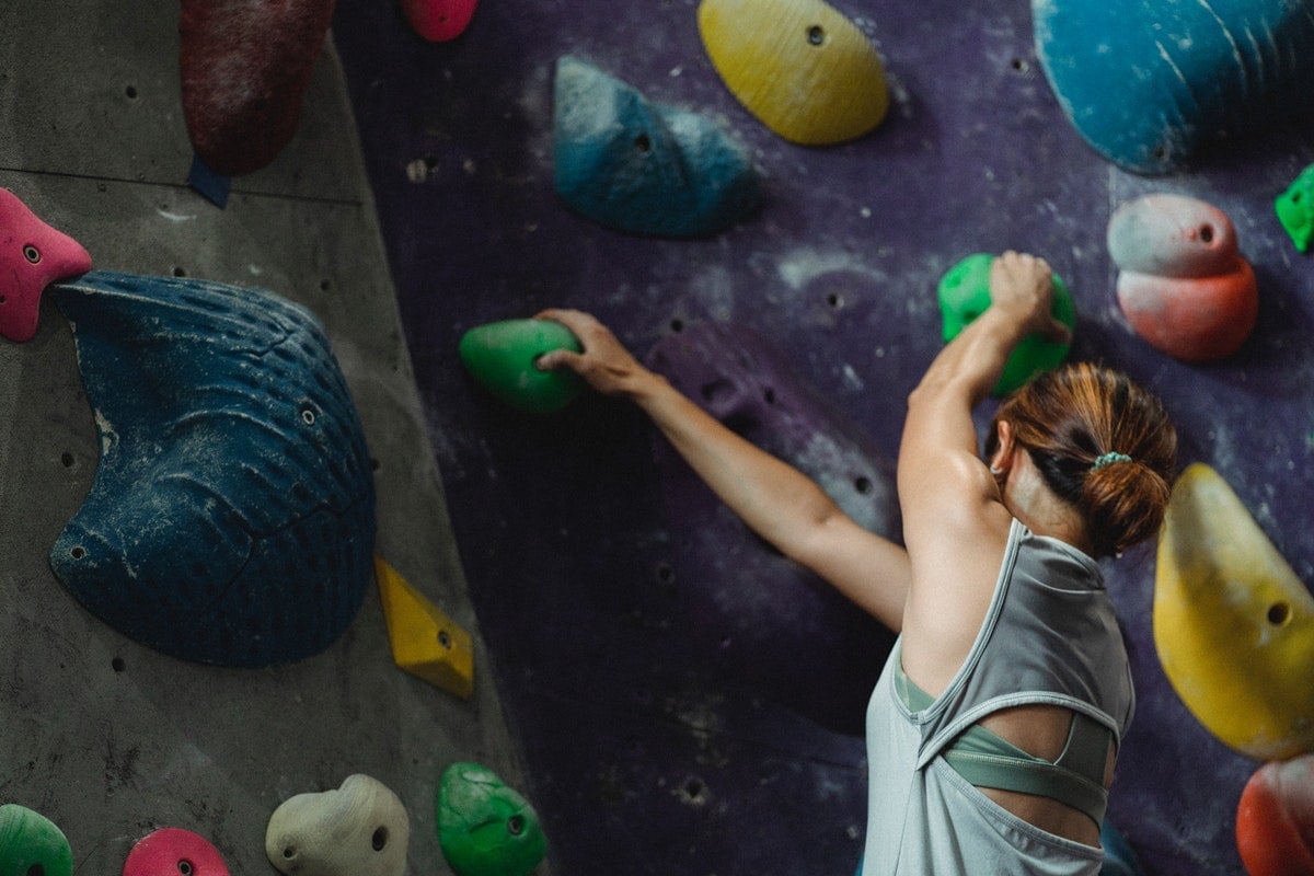 Woman climbing a rock climbing wall