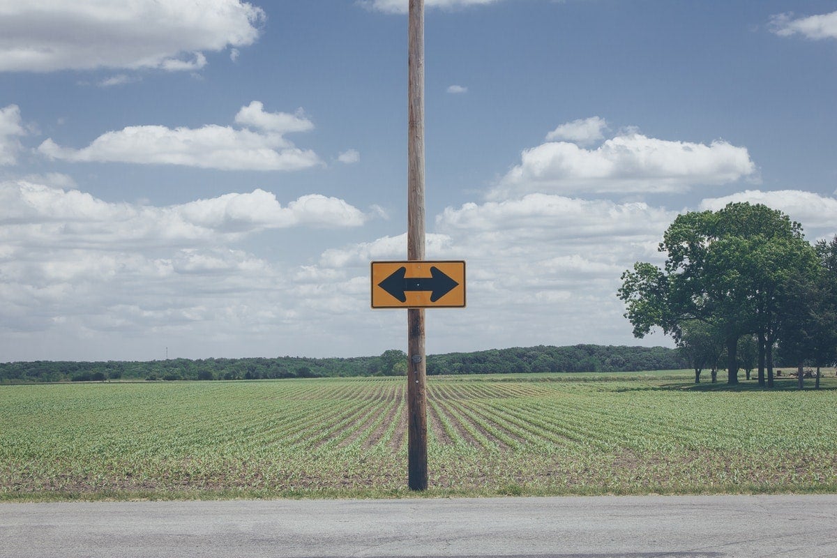 Sign on post pointing in two different directions